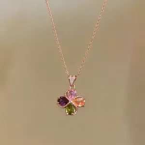 Close-up of elegant palace style flower pendant necklace with colorful teardrop zircons.