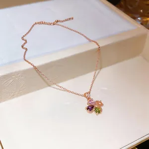 Close-up of elegant flower pendant with colorful teardrop zircons on rose gold chain