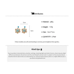 Detailed view of handmade raffia flower earrings with material specifications and size