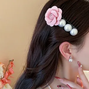 Elegant French style pink fabric rose hair clip with large white pearls for women's hairstyle.