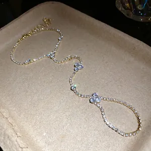 Elegant gold-tone tennis chain ring bracelet with sparkling flower accents