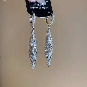 Close-up of 18K gold plated zircon hollow rhombus drop earrings with silver finish