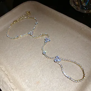 Close-up of a gold-plated rhinestone slave bracelet with elegant flower accents