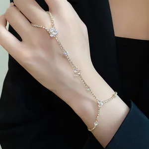 Elegant gold-tone hand harness with sparkling crystals for a sophisticated minimalist jewelry look
