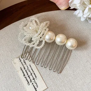 Elegant French style hair comb with white pearls and beaded flower detail close-up