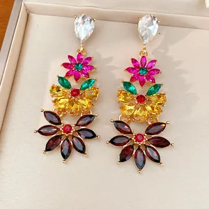 Detailed view of vintage-style floral drop earrings with vibrant multi-colored crystals.