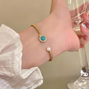 Elegant 18K gold-plated twisted cable open cuff bracelet with turquoise and pearl detail