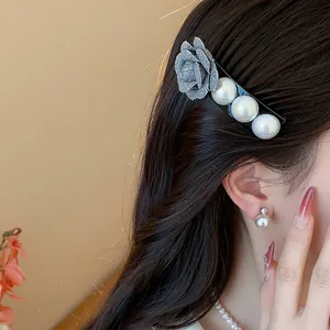 Elegant fabric rose and white pearl hair clip for women, detailed side view styling.