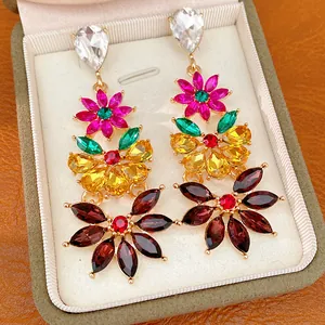 Close-up of vintage-style flower drop earrings with colorful crystals in a gift box