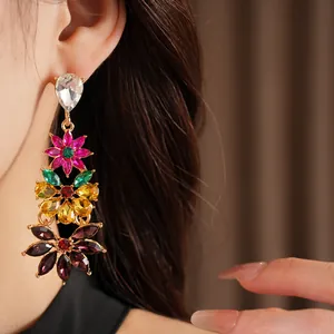 Close-up detail of vintage flower earrings with colorful crystals and rhinestones.