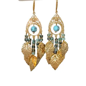 Ethnic style ornate gold tassel earrings featuring blue turquoise beads and green charms