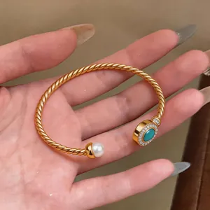 18K gold plated twisted cuff bracelet featuring a turquoise stone and pearl detail