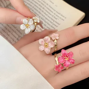 Close-up macro view of vintage oil-drop flower rings in white, light pink and deep rose colors