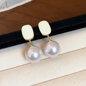 Macro detail of French style enamel square top with round lavender pearl drop earrings
