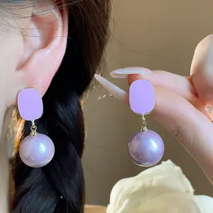 Detail view of elegant French style lavender dripping oil and purple pearl drop earrings