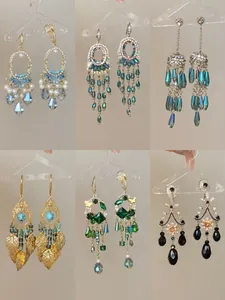 Detailed macro view of assorted ethnic style earrings featuring glass crystal beads and fringe tassels