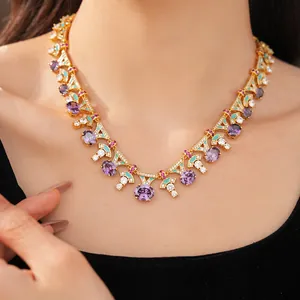 Detailed view of palace style gold necklace with purple oval zircon on female model