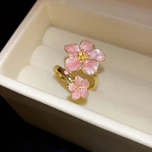 Elegant pink glitter enamel cherry blossom adjustable ring in a velvet gift box.