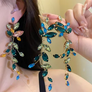Detailed view of luxury multicolor marquise crystal leaf vine tassel earrings on model