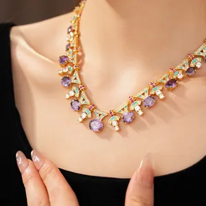 Close-up of a palace-style gold necklace with purple oval zircons and teal enamel.