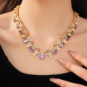 Detailed view of a palace-style gold necklace with purple zircons and turquoise enamel.