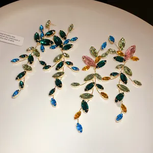 Close-up of elegant marquise-cut crystal tassel earrings with sparkling multi-color gems.