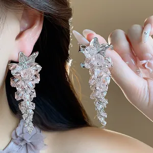 Elegant detail of pink glass bead flower tassel earrings with silver needle studs
