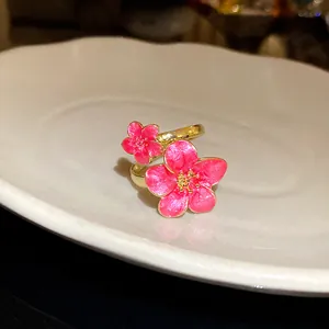 Close-up detail of vintage style pink enamel cherry blossom flower adjustable gold ring