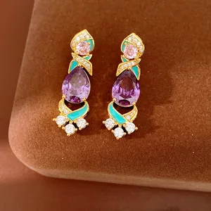Close-up detail of vintage-style purple zircon earrings with turquoise enamel