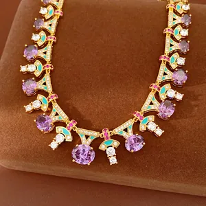 Detailed close-up of a royal style gold necklace with purple zircons and teal enamel accents