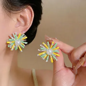 Exquisite colorful sunburst flower stud earrings with central pearl and silver needles