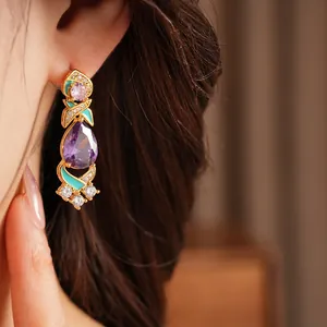 Detail shot of luxury palace style earring with purple teardrop zircon and mint enamel.