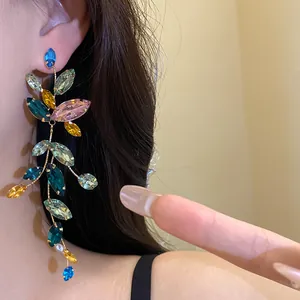 Close-up of multi-colored crystal tassel earrings with sparkling rhinestones.