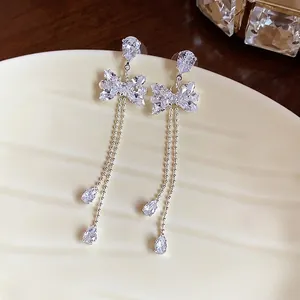 Elegant silver needle bow tassel earrings with sparkling cubic zirconia stones