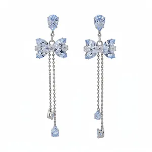Elegant bow knot dangle earrings with blue cubic zirconia and long silver tassels