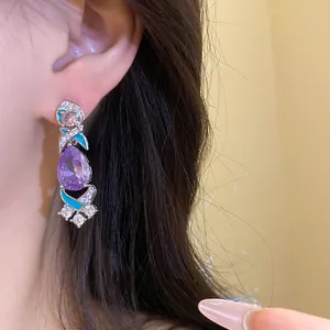 Nahaufnahme eleganter lila Zirkon-Ohrhänger mit türkisfarbenem Emaille und Silberfinish