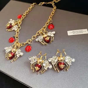 Vintage insect jewelry set with crystal bee and red enamel ladybug motifs on gold chain