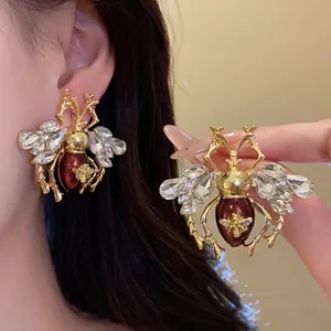 Vintage insect stud earrings with sparkling rhinestones and reddish brown enamel drip oil