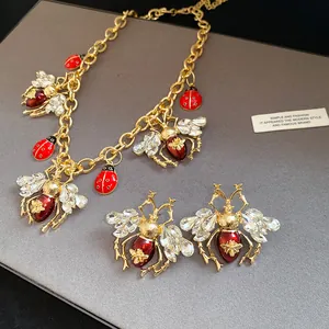 Close-up of vintage insect jewelry set with rhinestone bees and enamel ladybugs