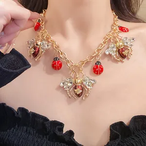 Close-up of a vintage insect necklace featuring crystal ladybug and bee charms.