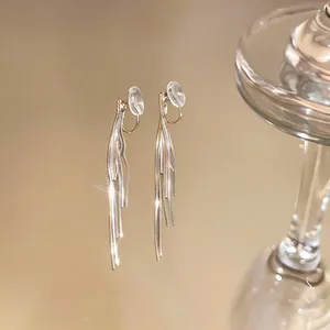 Close-up shot of elegant gold long tassel clip-on earrings featuring a high-shine metallic finish
