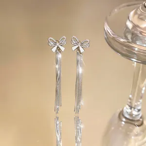 Elegant silver tassel earrings featuring a sparkling zircon-studded bow-knot design.