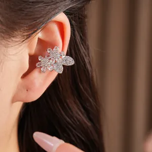 Exquisite silver zircon flower and butterfly ear cuff shown as a close-up on a model
