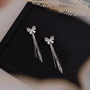 Elegant bow tassel stud earrings with sparkling zirconia stones in high-end silver finish