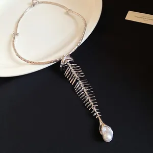 Detailed close-up of a heavy vintage silver fishbone choker necklace with pearl pendant