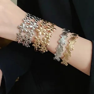 Elegant vintage floral metal open bangles in gold and silver finish worn on wrist