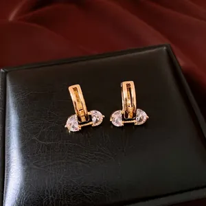 Elegant 18K gold plated oval hoop earrings with clear zircon stones on black jewelry box