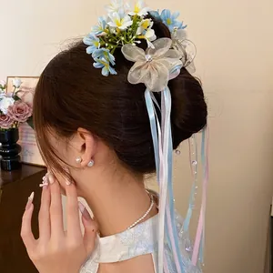 Elegant ballet-style flower hair clip with long colorful ribbons for bun hairstyles.