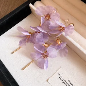 Elegant detailed view of lavender purple mesh flower tassel earrings in a white box