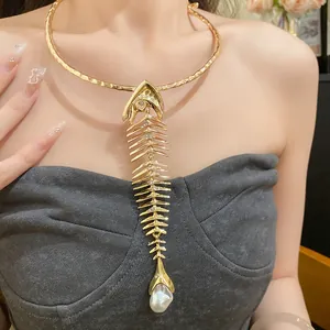 Close-up of vintage gold fishbone pendant necklace with elegant teardrop pearl detail